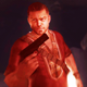 The Jackal from Far Cry 2 wearing a red shirt and holding a pistol as seen in the game's opening.